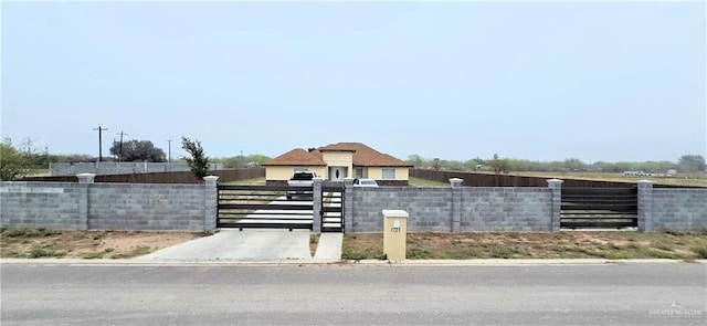 view of front of house featuring a fenced front yard and a gate