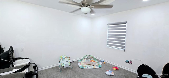 interior space with carpet flooring, a ceiling fan, and baseboards