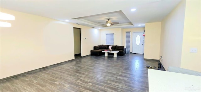 living area featuring a tray ceiling, wood finished floors, a ceiling fan, and recessed lighting