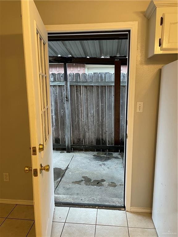 entryway with light tile patterned floors and baseboards