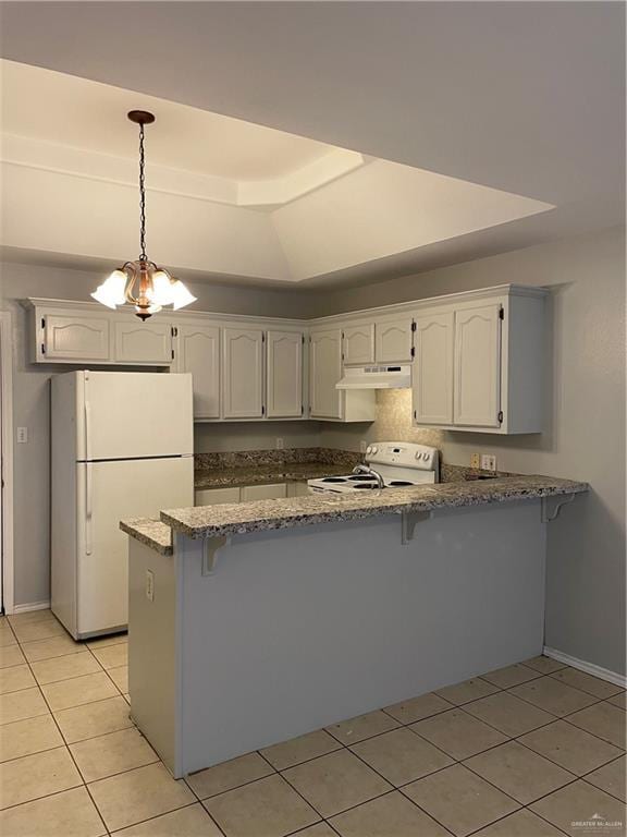 kitchen featuring a peninsula, white appliances, white cabinetry, and decorative light fixtures