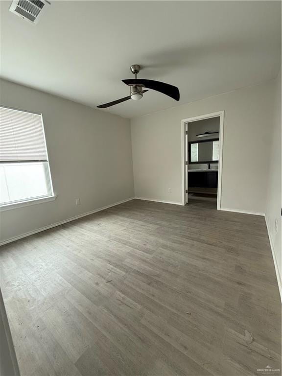 unfurnished room with dark hardwood / wood-style floors and ceiling fan