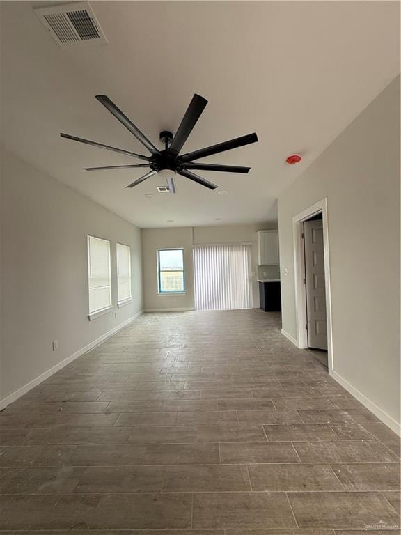 unfurnished room with hardwood / wood-style flooring and ceiling fan