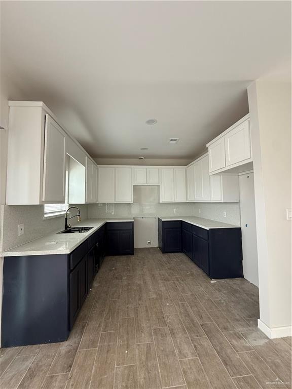 kitchen with white cabinetry and sink