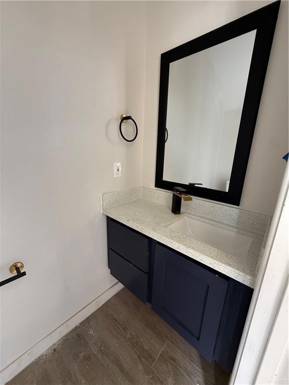 bathroom with vanity and wood-type flooring