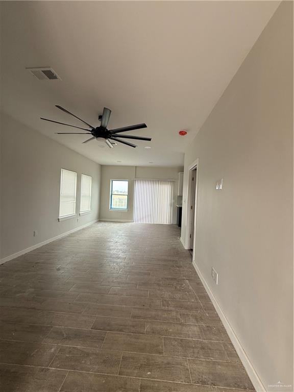 empty room with hardwood / wood-style flooring and ceiling fan