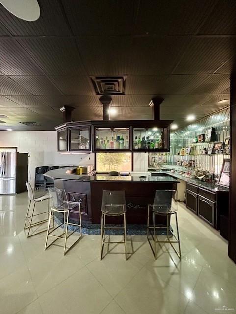 2417 E 28th St, Mission, TX 78574 - bar area featuring stainless steel refrigerator with ice dispenser and light tile patterned flooring