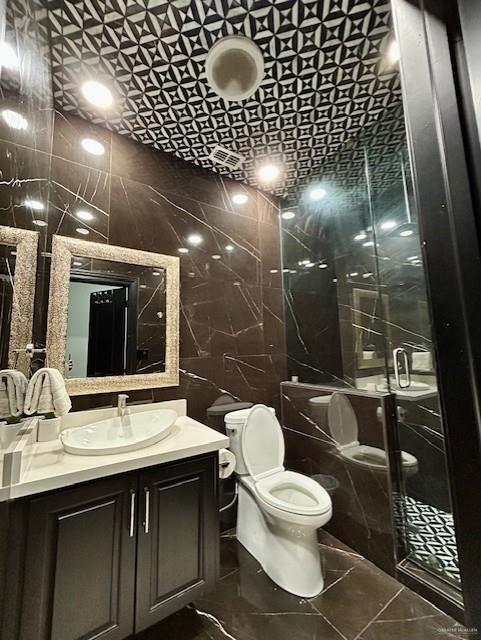 2417 E 28th St, Mission, TX 78574 - bathroom featuring tile walls, vanity, and a stall shower