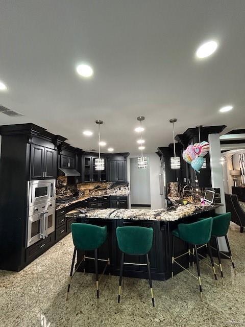 2417 E 28th St, Mission, TX 78574 - kitchen with stainless steel appliances, dark cabinets, backsplash, glass insert cabinets, and a peninsula