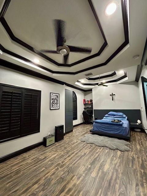 2417 E 28th St, Mission, TX 78574 - bedroom with a raised ceiling, wood finished floors, crown molding, arched walkways, and a ceiling fan