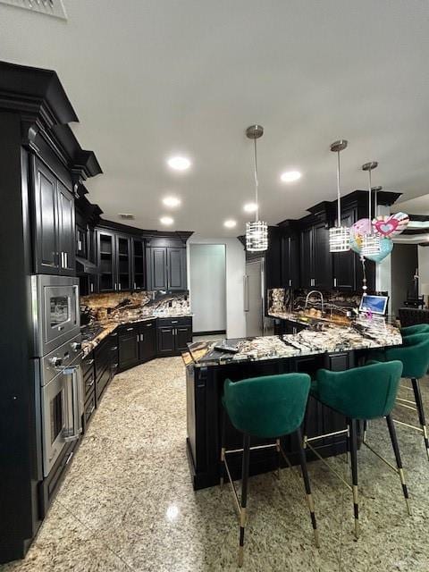 2417 E 28th St, Mission, TX 78574 - kitchen featuring dark cabinetry, backsplash, glass insert cabinets, a breakfast bar, and recessed lighting