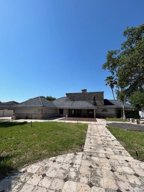 2417 E 28th St, Mission, TX 78574 - view of front facade featuring driveway, a front yard, and a garage