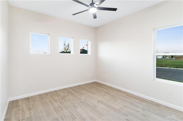 spare room featuring light hardwood / wood-style floors and ceiling fan