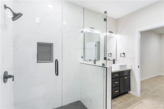 bathroom featuring vanity and an enclosed shower