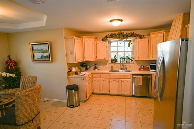 kitchen featuring sink, light tile patterned floors, light brown cabinetry, tasteful backsplash, and stainless steel appliances