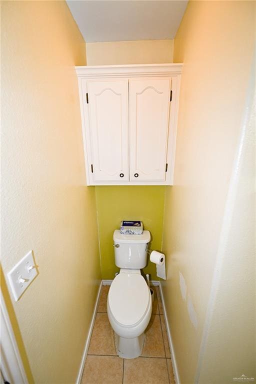 bathroom with tile patterned flooring and toilet