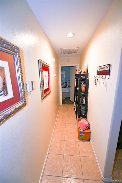 hall featuring light tile patterned floors