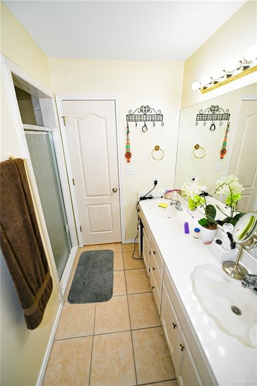 bathroom with tile patterned floors, vanity, and a shower with shower door