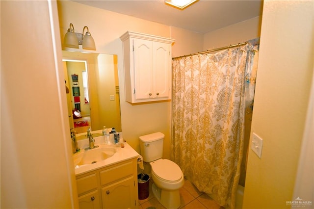 bathroom with tile patterned flooring, vanity, and toilet