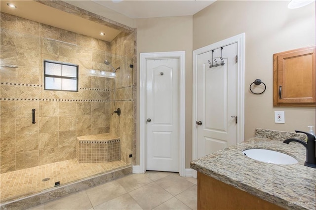 bathroom with vanity, an enclosed shower, and tile patterned flooring