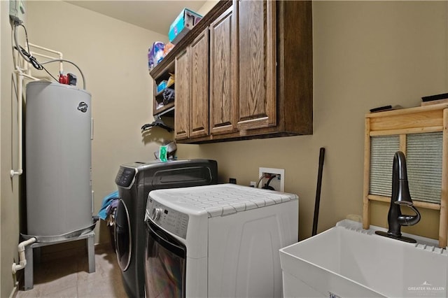 1802 E Thompson Rd, Mission, TX 78573 - laundry room featuring washer and dryer, water heater, and cabinet space