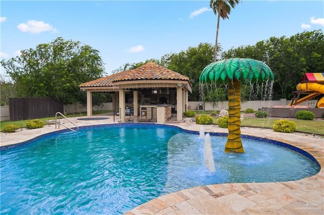 1802 E Thompson Rd, Mission, TX 78573 - view of pool featuring a gazebo, an outdoor kitchen, a fenced backyard, a patio, and an outdoor bar