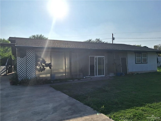 rear view of house with a lawn