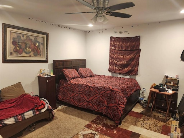 bedroom with ceiling fan and light colored carpet