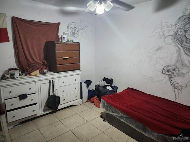 bedroom with ceiling fan and light tile patterned flooring