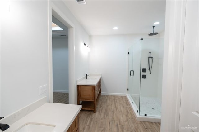 bathroom featuring hardwood / wood-style floors, vanity, and an enclosed shower