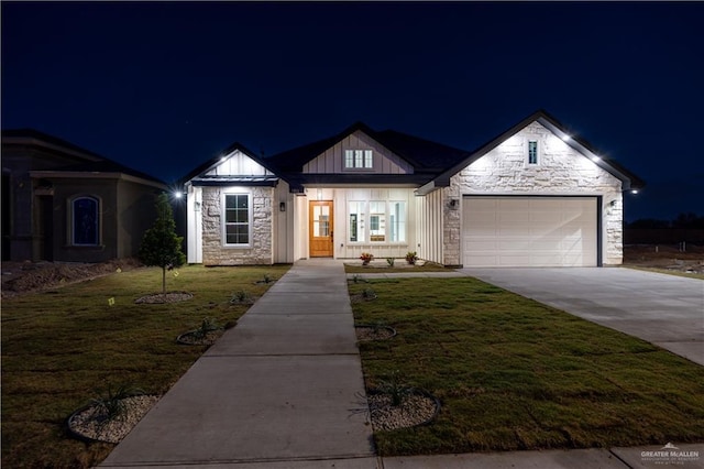 view of front facade with a garage and a yard