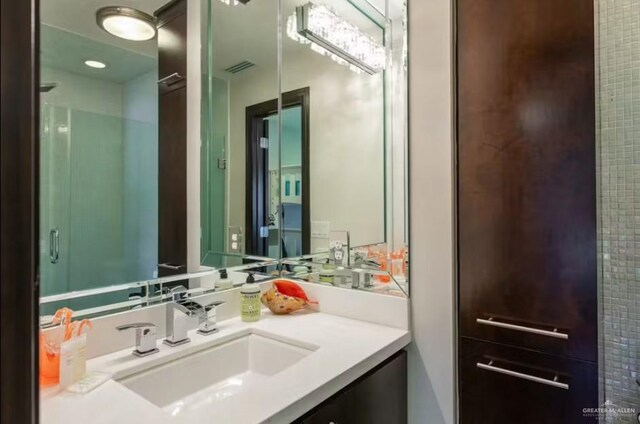 111A E Oleander St, South Padre Island, TX 78597 - bathroom with vanity and a shower with door