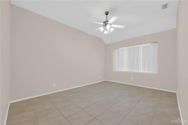 empty room featuring baseboards, lofted ceiling, ceiling fan, and light tile patterned floors