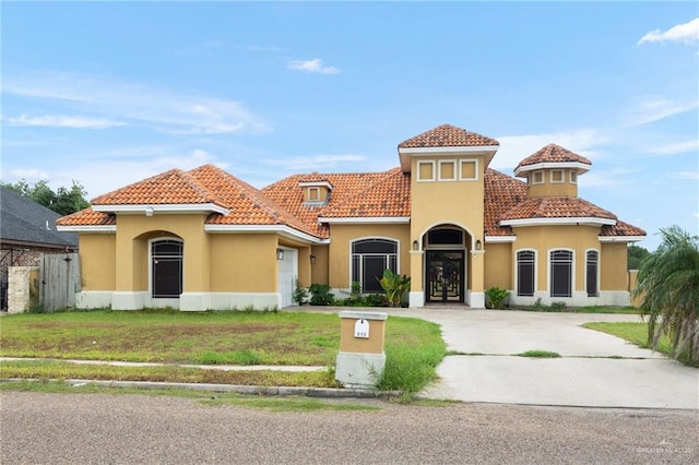 mediterranean / spanish-style house with a front yard