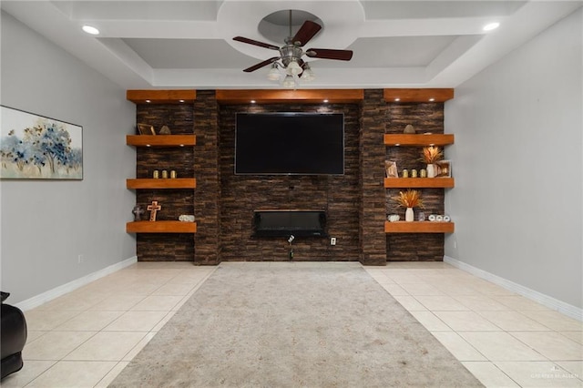 living room with a tray ceiling, ceiling fan, and light tile patterned flooring