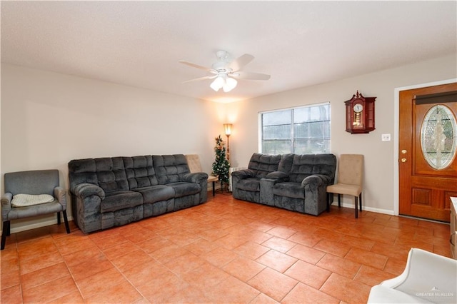 living room with light tile patterned flooring, a ceiling fan, and a wealth of natural light