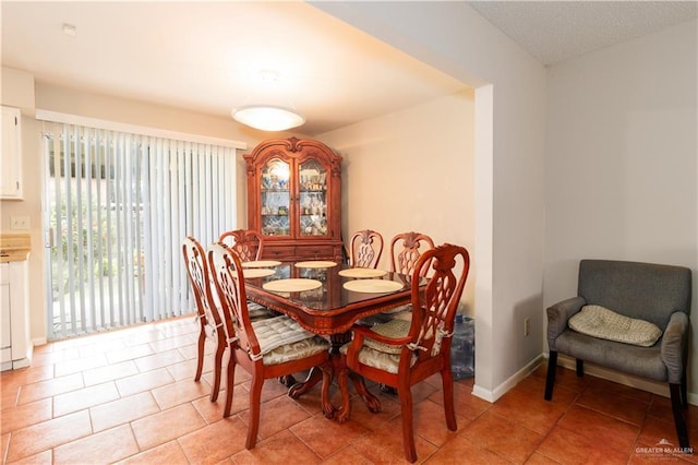 dining room featuring light tile patterned flooring and baseboards