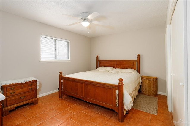 bedroom featuring light tile patterned flooring, a ceiling fan, and baseboards