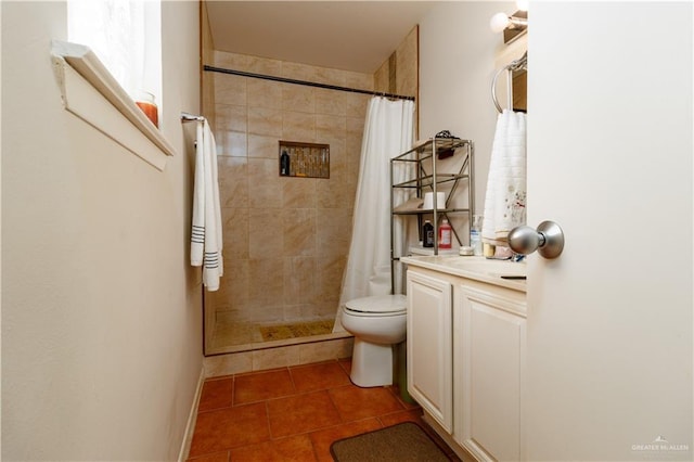 full bath featuring tile patterned floors, toilet, vanity, and tiled shower
