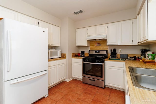 kitchen featuring white cabinets, visible vents, light countertops, under cabinet range hood, and white appliances