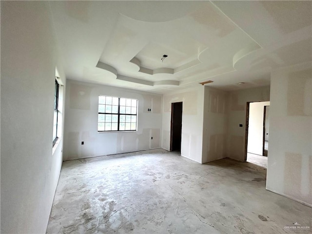 empty room featuring a raised ceiling