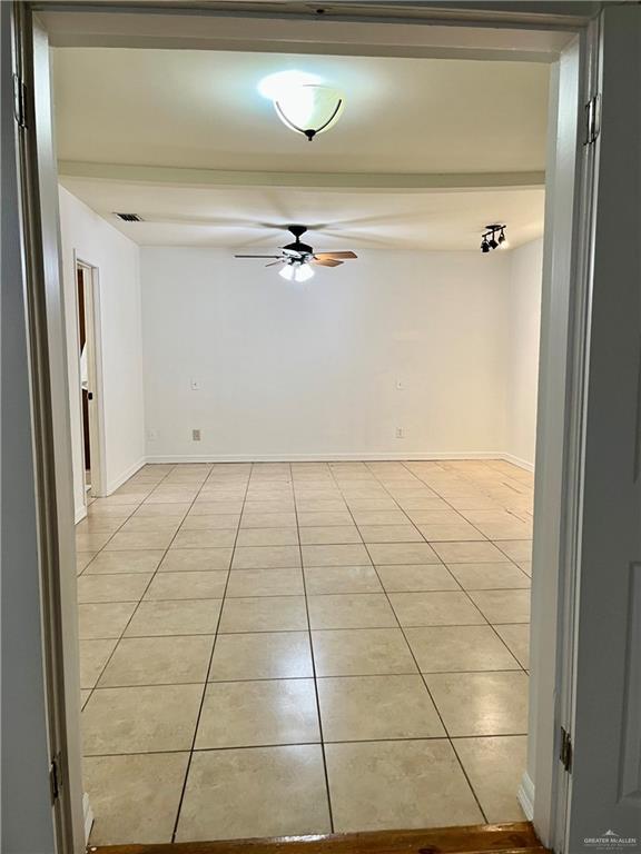 unfurnished room featuring ceiling fan and light tile patterned flooring