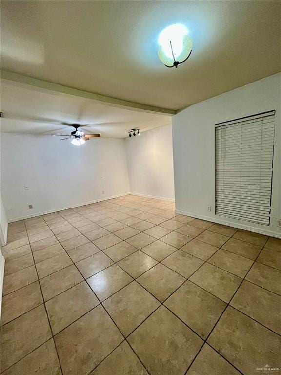 tiled spare room with ceiling fan