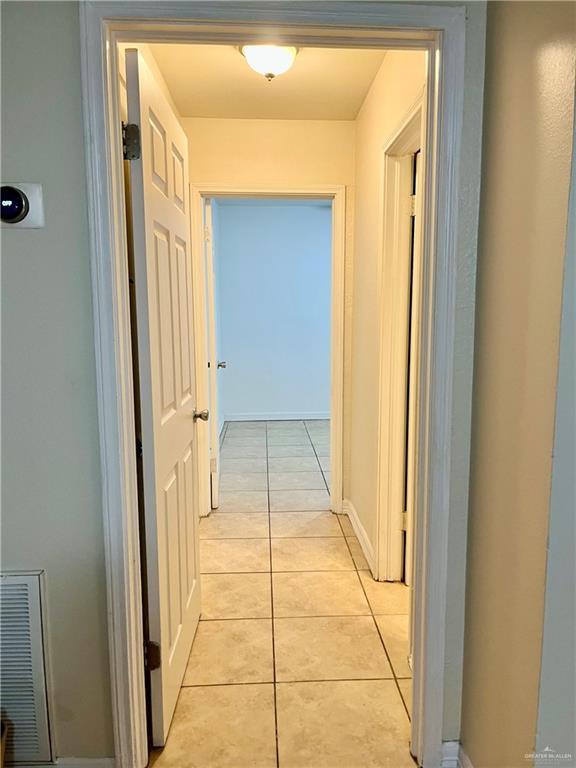 hall featuring light tile patterned floors