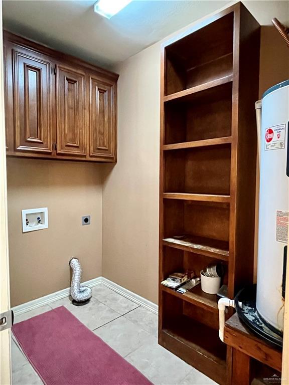 laundry room featuring hookup for a washing machine, water heater, light tile patterned floors, electric dryer hookup, and cabinets