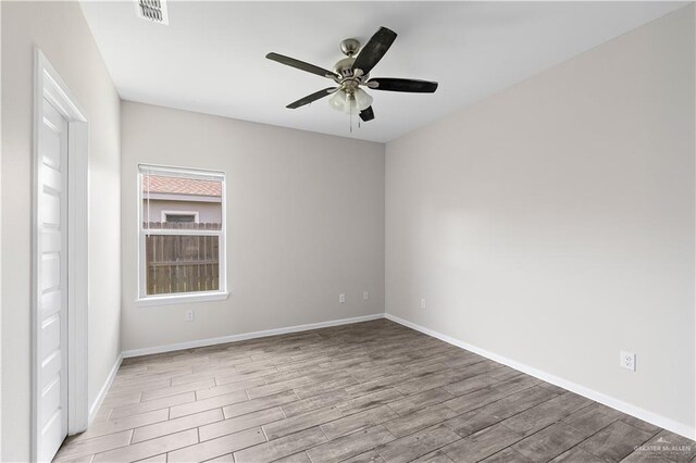 912 Kentucky St, Alton, TX 78573 - spare room featuring wood finished floors, ceiling fan, and baseboards