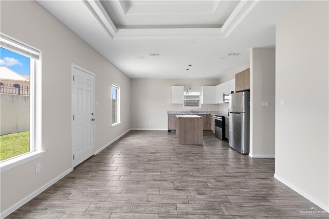 912 Kentucky St, Alton, TX 78573 - kitchen featuring stainless steel appliances, a kitchen island, open floor plan, and plenty of natural light