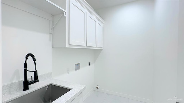 laundry area featuring hookup for an electric dryer, cabinets, sink, and hookup for a washing machine