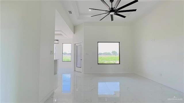 unfurnished room featuring a tray ceiling, crown molding, and ceiling fan