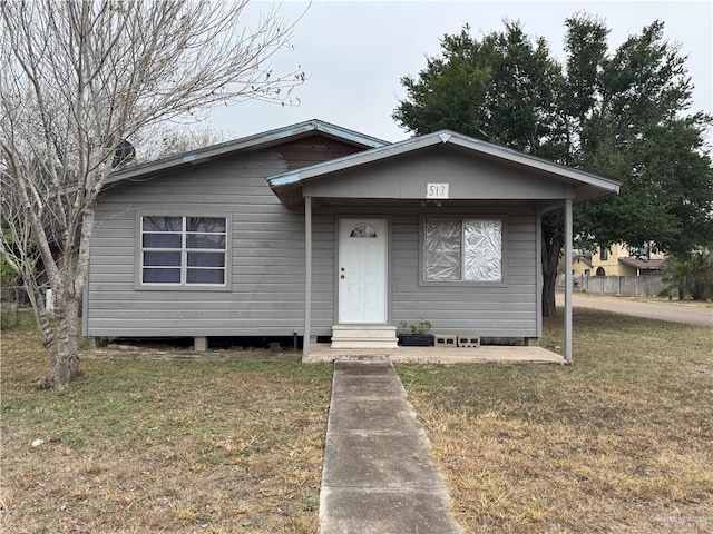 bungalow-style home with a front lawn